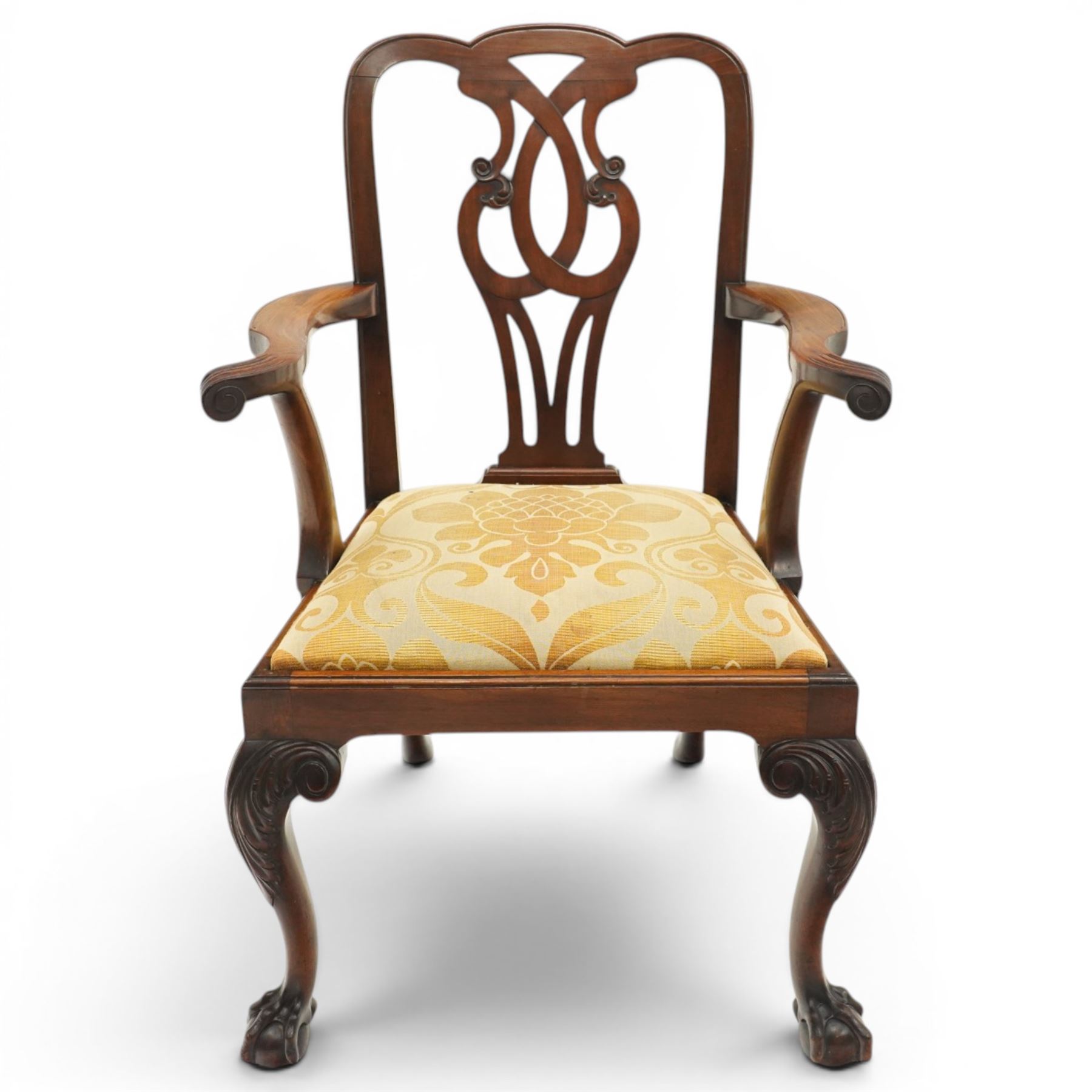 Late 19th century Chippendale style mahogany desk chair, with pierced splat and shaped and scrolled arms, raised on front claw and ball supports