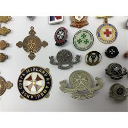 Collection of St John Ambulance enamel and metal badges, together with Red Cross medals and badges
