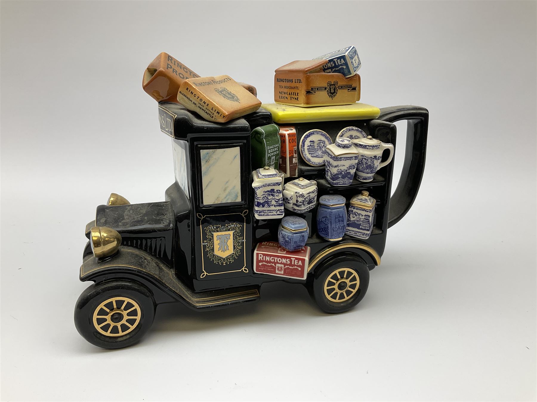 Three Ringtons novelty teapots, comprising The Ringtons Van teapot, the Tea Merchant teapot, and Millenium Celebration teapot. 