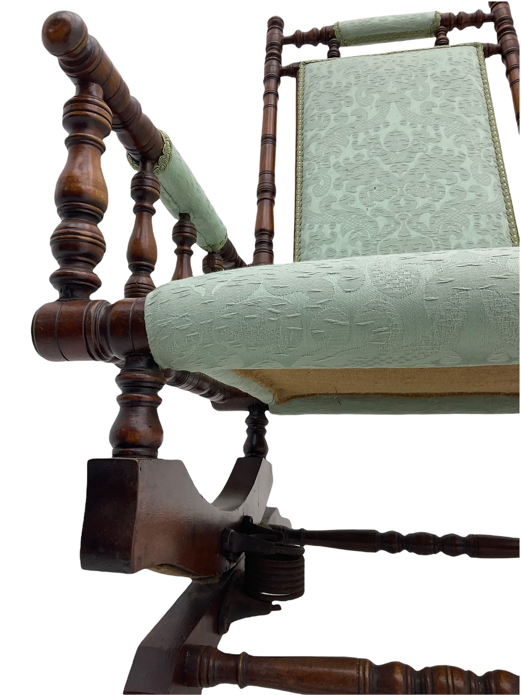 Early 20th century walnut framed American rocking chair, upholstered seat, back and arms