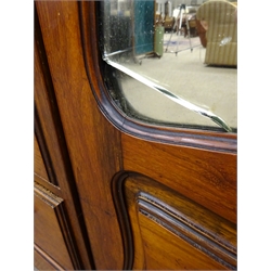  Edwardian walnut triple combination wardrobe, projecting cornice, carved foliage frieze, two shaped mirror doors enclosing fitted interior flanking central panelled cupboards above three glazed doors and four graduating drawers on plinth base, W196cm, H225cm, D64cm  