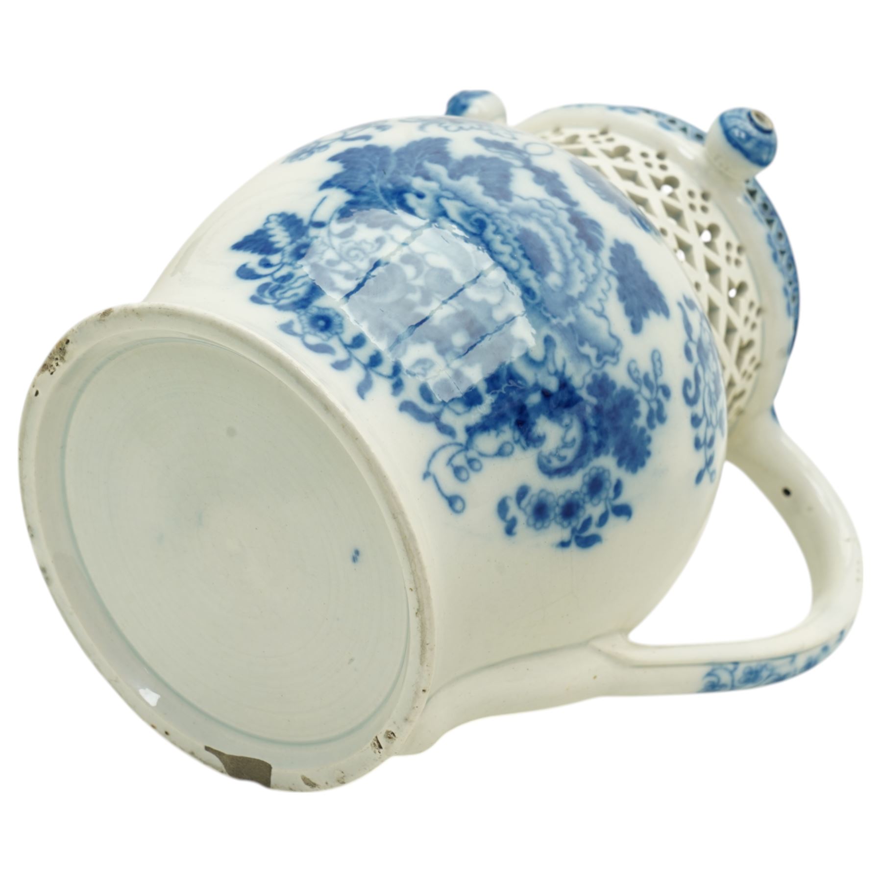 Swansea Cambrian pottery pearlware puzzle jug, c.1810, decorated in underglaze blue with peonies and sprigs of flowers, the straight-neck with three hollow spouts and openwork decoration, H18cm 