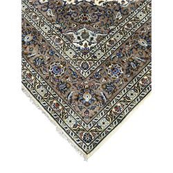 Persian Kashan ivory ground carpet, central medallion on a field of scrolling foliate branches decorated with palmettes, the border decorated with repeating stylised plant motifs, floral design guard stripes