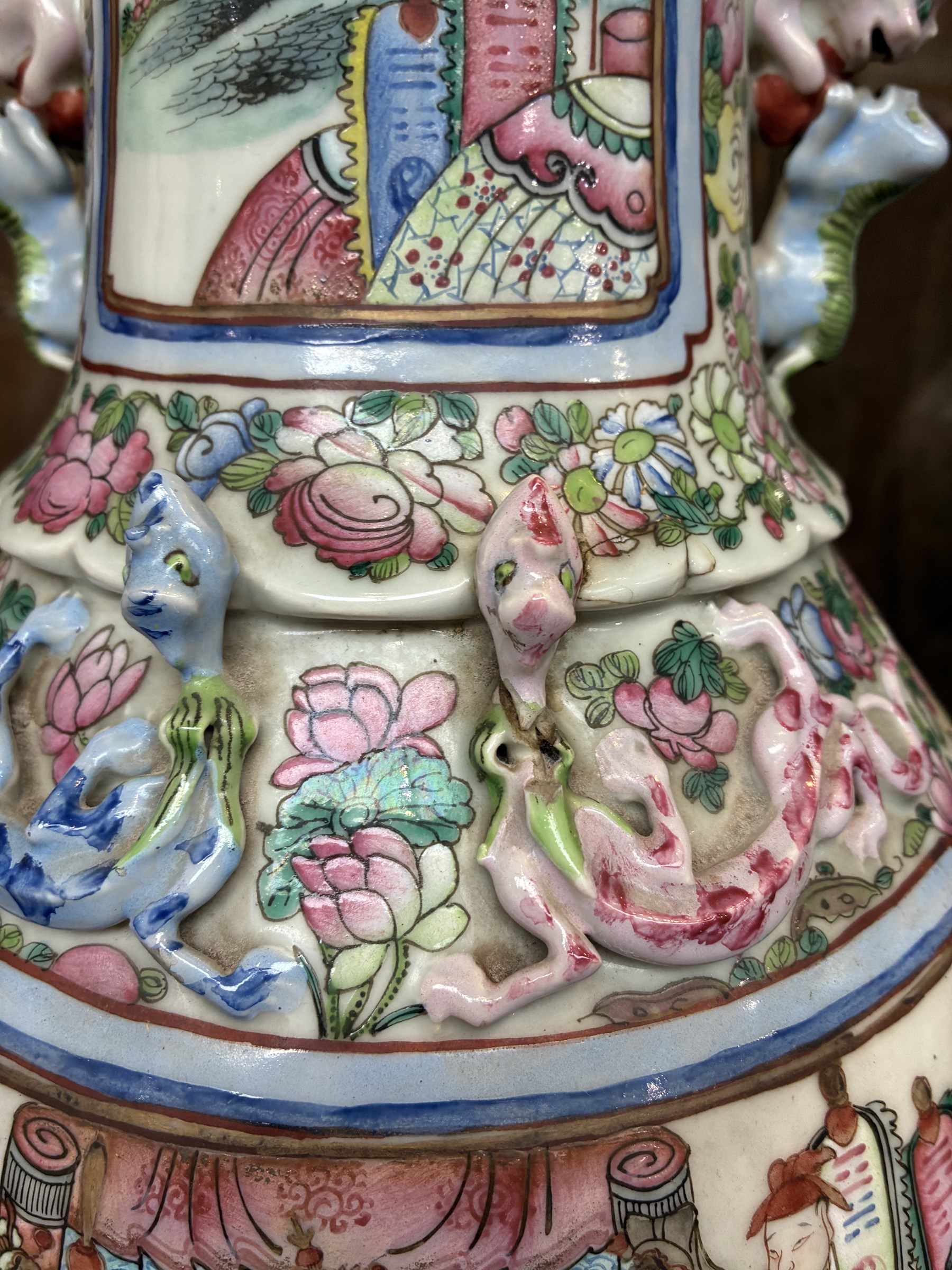 Large pair of 19th century Cantonese famille rose vases, each painted with various courtly scenes, including a display of warriors fighting on horseback before an official and his attendants, double Buddhist lion handles and applied at the shoulders with chilong, the lower band painted with Greek key motif, H58cm (2)