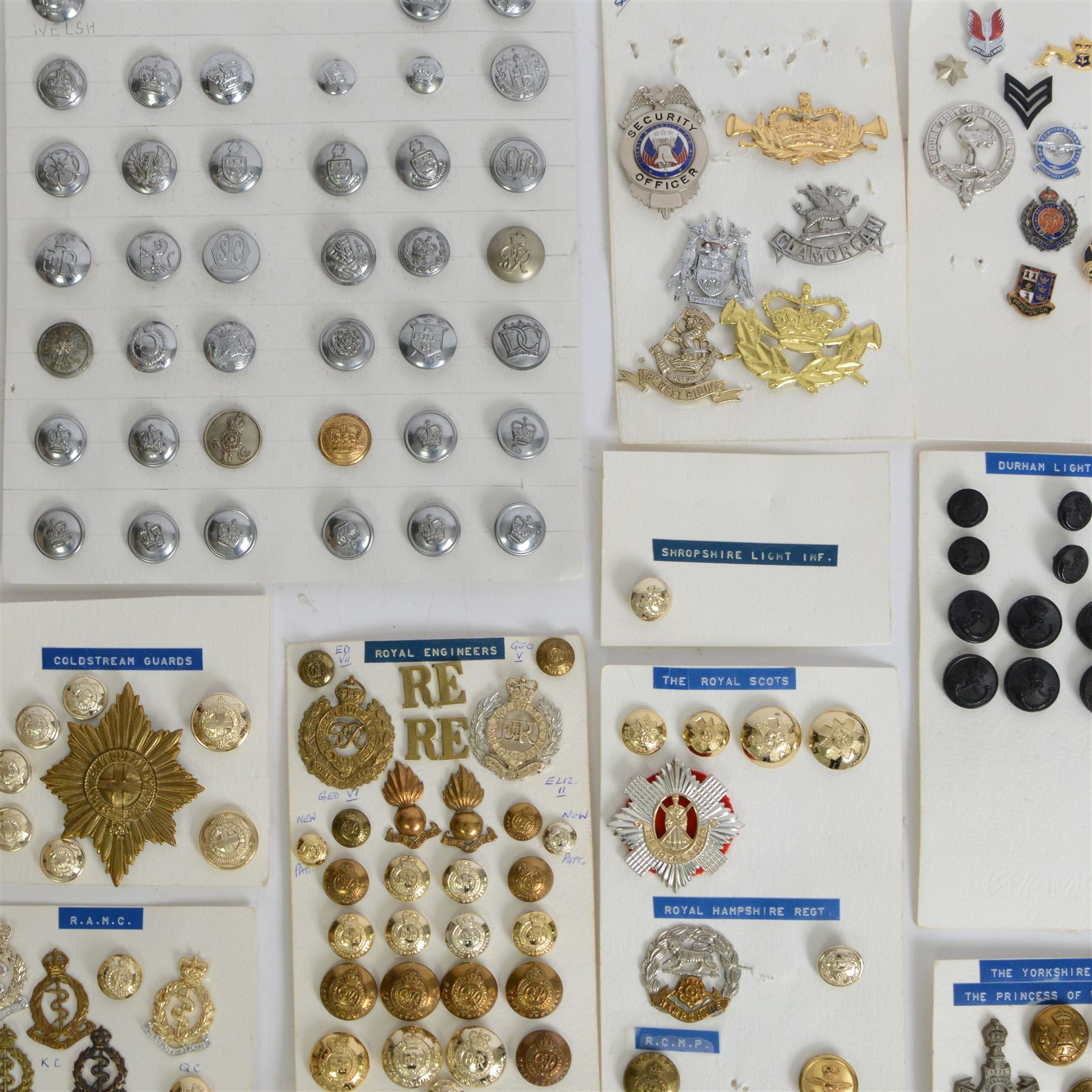 Collection of military cap badges, buttons and similar, including examples for Royal Army Medical Corps, Royal Army Pay Corps, Royal Engineers etc 