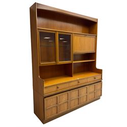 Nathan - teak wall unit, fitted with raised display cabinet and fall front compartment, three drawers and three cupboards below