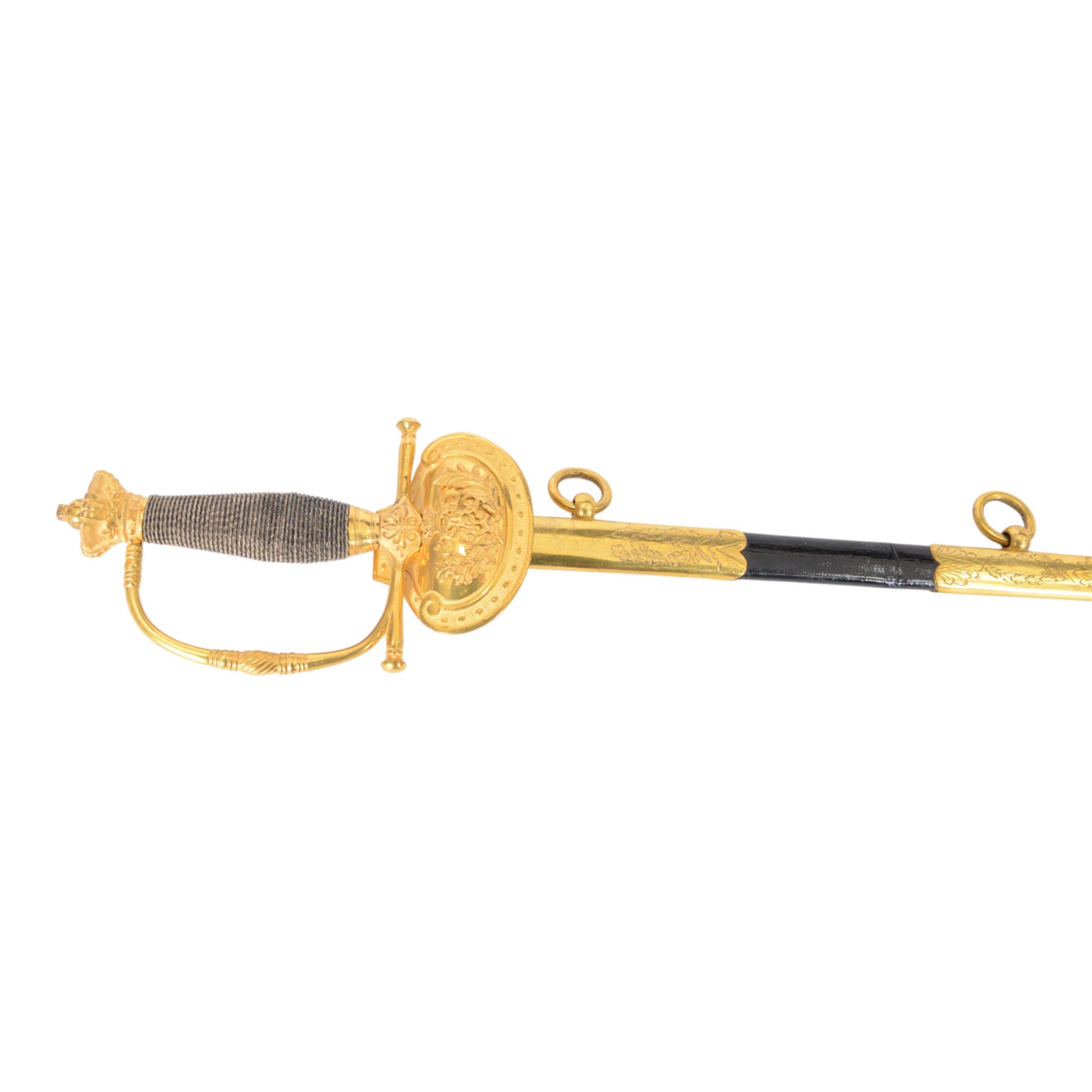 British Victorian court sword, for members of the Royal Household, by W.K & C of Solingen and retailed by Besch of Hanover St London, the 80cm blade etched to both side, the single bar hilt of gilt brass with Queens' crown pommel and downturned shell guard with the monogram of Queen Victoria, the wooden grip covered with silver wire, within leather scabbard with three gilt brass mounts and twin suspension rings, overall L96cm   