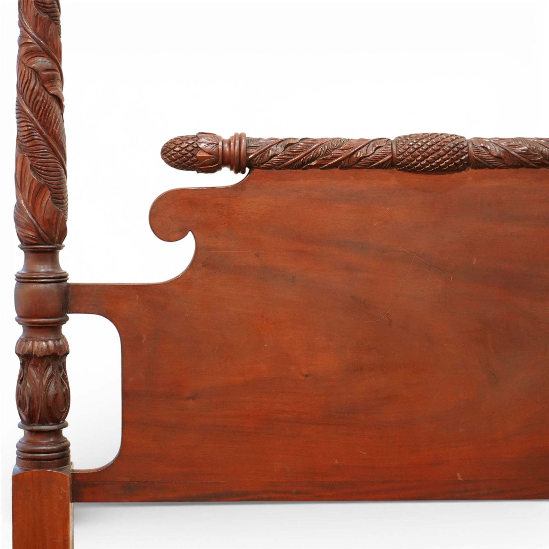 Early 19th century Regency carved mahogany four poster double bed, 4'6, the shaped headboard and footboard each surmounted by a finely carved pinecone and foliate moulded rail, flanked by ring turned and boldly spiral carved tapering posts with acorn finials, raised on square section legs, with slatted base