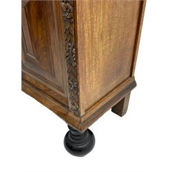 Late 17th century Flemish/Dutch rosewood and oak ‘Zeeuwse Kast’ or cupboard, projecting cornice carved with three putti masks, the uprights carved with lion masks over ribbons, flower heads and foliage, enclosed by four geometric panelled doors, lower central upright carved with flower head over foliate ribbon with bird among foliage, the escutcheon hidden by swivel berry carved cover, interior fitted with shelves, two drawers and shallow hinged cupboard, on two large turned and ebonised feet, circa 1680