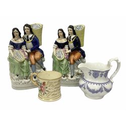 Victorian mug decorated with painted blossoming sprays and gilding, bearing poem, together with a mid 19th century jug with applied periwinkle blue decoration on white ground, and two Staffordshire style figure groups depicting a seated gentleman and woman with baskets