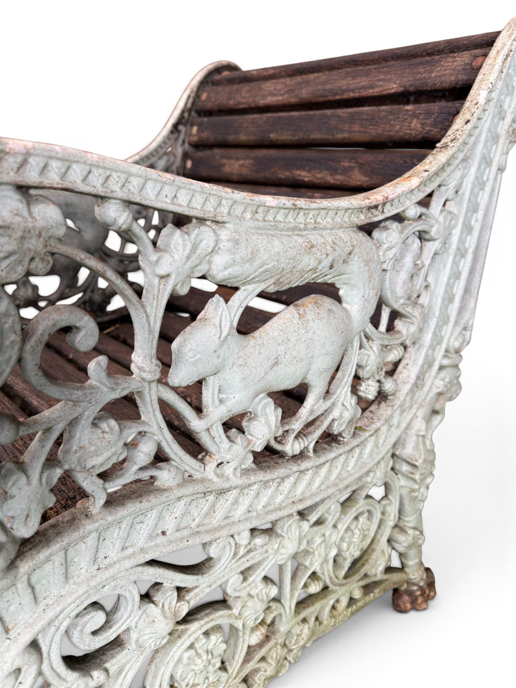 Pair of unusual Victorian revival heavy cast iron garden chair benches, ornate scrollwork detail with squirrels and nature, serpentine wood slatted seat and back - design by George Smith at the Sun Foundry, Glasgow