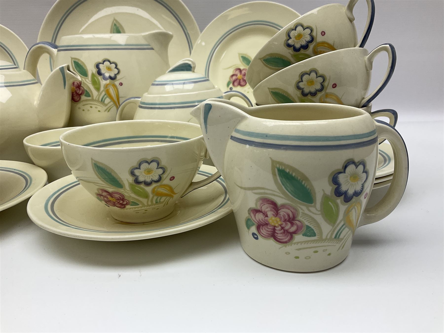 Susie Cooper Nosegay pattern tea service, teapot, eight cups and saucers, six dessert plates, three graduating jugs, covered twin handled sucrier, open sucrier  and cake plate 