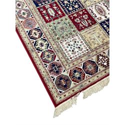 Bakhtiari design rug, the field divided into panels each decorated with tree of life and floral motifs, the main border decorated with Hac motifs 