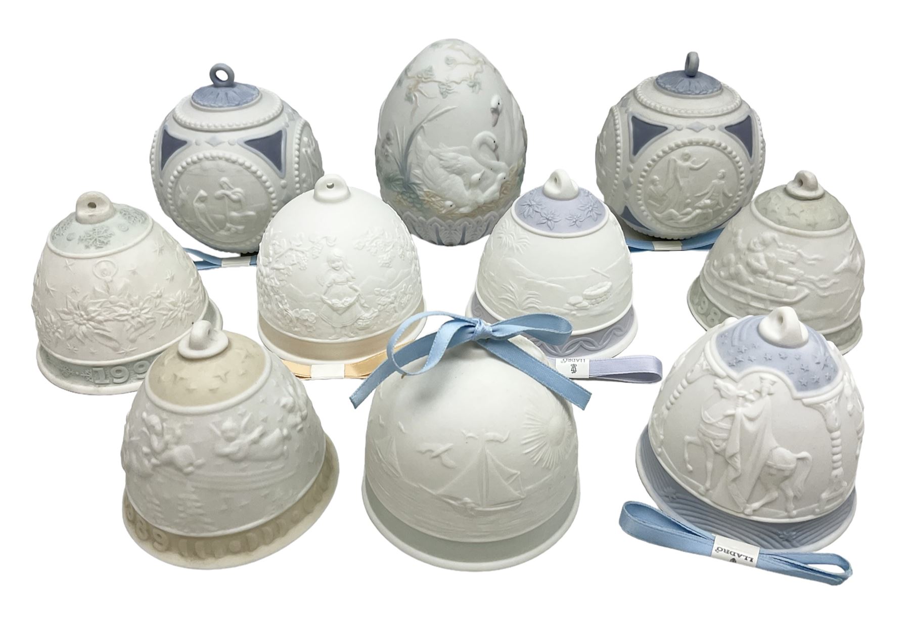Seven Lladro bells, comprising Summer no 17614, Fall 17615, Christmas 1988 no 5525, Christmas 1989 no 5616,  Christmas 1990 no 5641, Christmas 1992 no 15913 and Christmas 1993 no 16010, together with two Lladro Christmas balls no 1603 and Lladro easter eggs 1994 no 17532