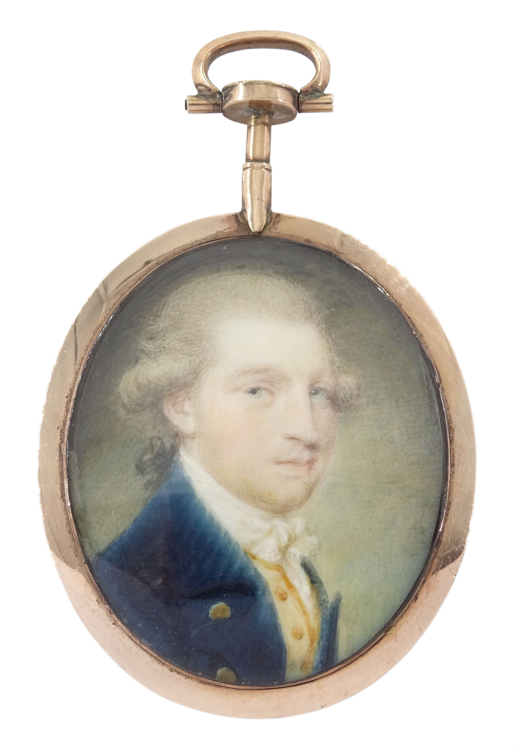 Samuel Shelley (British 1750-1808)
Portrait miniature upon ivory, circa 1790
Head and shoulder portrait of a gentleman in blue coat and yellow waistcoat 
Within period gold fausse-montre case with hair work verso
Oval 3.75cm x 3cm

Samuel Shelley first exhibited at the Society of Artists in 1773, entering the Royal Academy Schools the following year where he exhibited work up until 1804. 
Largely considered to have been self-taught, Samuel Shelley worked in a range of mediums throughout he career, producing watercolours, oils, book illustrations and engravings, but is arguably best known for his miniature portraits in watercolour, a medium which he championed establishing the first watercolour society in around 1804.
Shelley was a prominent and popular miniaturist during his time, and today his works feature in many major museums.  
