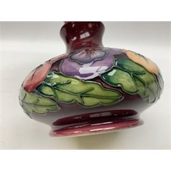 Moorcroft vase, of squat bulbous form, decorated in the Pansy pattern upon a maroon glazed ground, with painted mark beneath, with original box, H11cm
