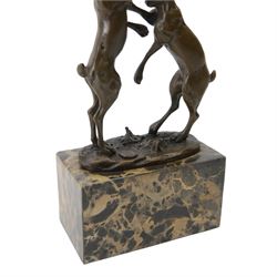 Mario Nick (Modern): two hares boxing, bronze figure group, signed Nick and bearing foundry mark, upon rectangular stone plinth, overall H23.5cm
