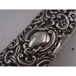 Group of silver, comprising Victorian silver hair brush and matching clothes brush, with repousse floral and scroll decoration, and each engraved with lion rampant to central cartouche, hallmarked Henry Matthews, Birmingham 1895, together with a 1920s miniature silver mounted photograph frame, hallmarked Charles Edwin Turner, Birmingham 1925 H7cm, and a Georgian silver Hanoverian pattern teaspoon, with scroll decoration to underside of bowl and engraved initials verso, hallmarks worn and indistinct