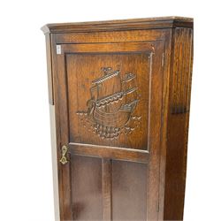 Early to mid-20th century oak hall wardrobe, the panelled door decorated in relief with sailing scene carving