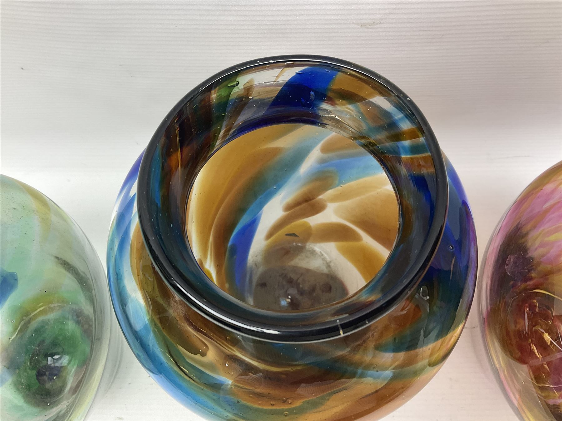 Three Hartley Wood coloured glass vases, each of baluster form with swirling decoration, tallest H21cm