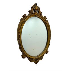 Giltwood oval wall mirror with carved Rococo-style frame, scrolling acanthus leaves and pierced crest (H71cm); smaller oval mirror with floral pattern and openwork scrolls, surmounted by a rose crest (H54cm)