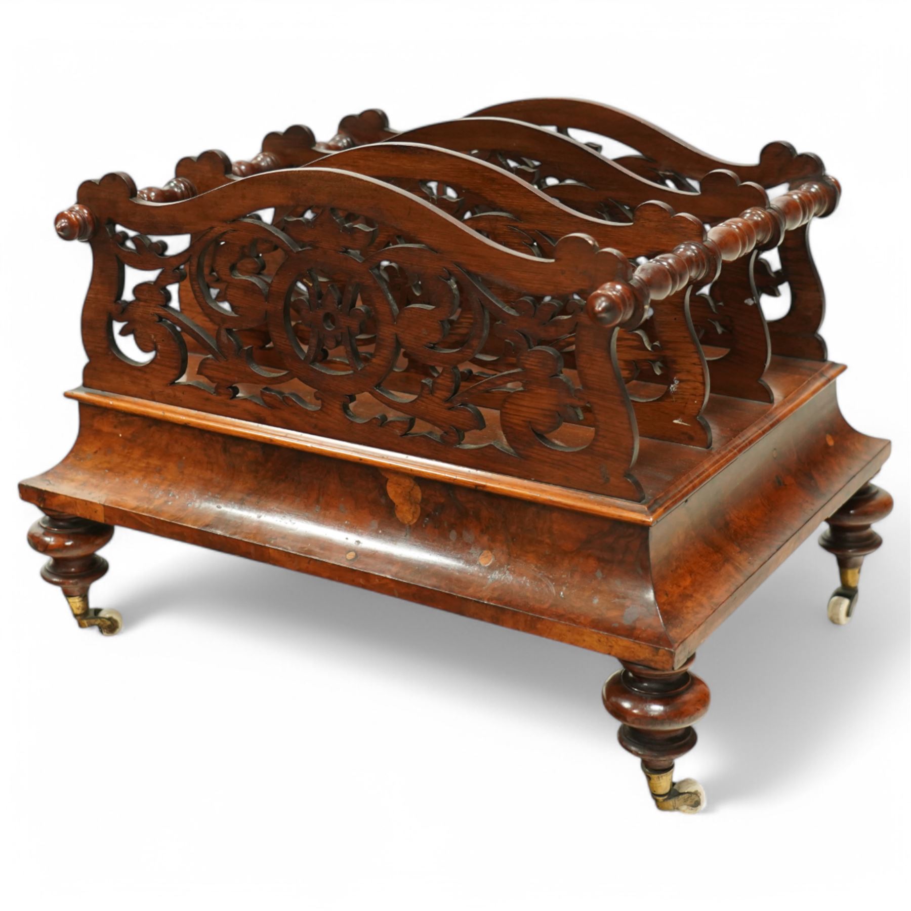  Victorian, walnut Canterbury- magazine rack with four fretwork upstands, drawer to base, standing on turned legs terminating in original castors. circa 1880