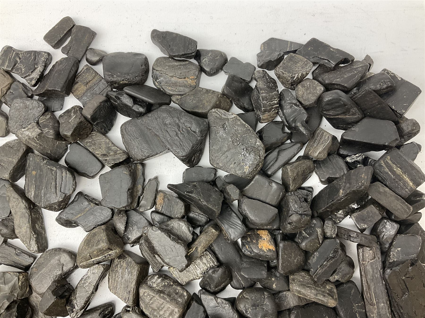 Collection of raw Whitby jet including large piece with one polished side, approx 4lbs