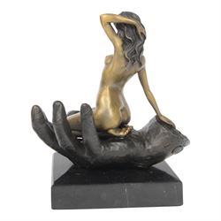 Nude In Hand bronze sculpture modeled as a female nude seated in a hand upon a marble base, signed June H24cm   