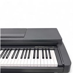 Yamaha Clavinova CLP-550 digital piano, full-size weighted keyboard with integrated pedals and speakers, in dark wood effect casing, accompanied by matching padded bench, Sennheiser headphones, original manuals, and factory-issued cassette tape titled 'Pure & Simple – CLP Digital Pianos'