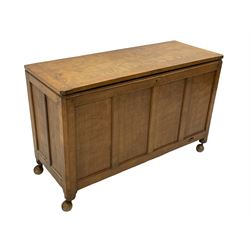 'Mouseman' oak blanket box, hinged adzed top, all round panelling, raised on castors, relief carved inset mouse signature, by Robert Thompson of Kilburn