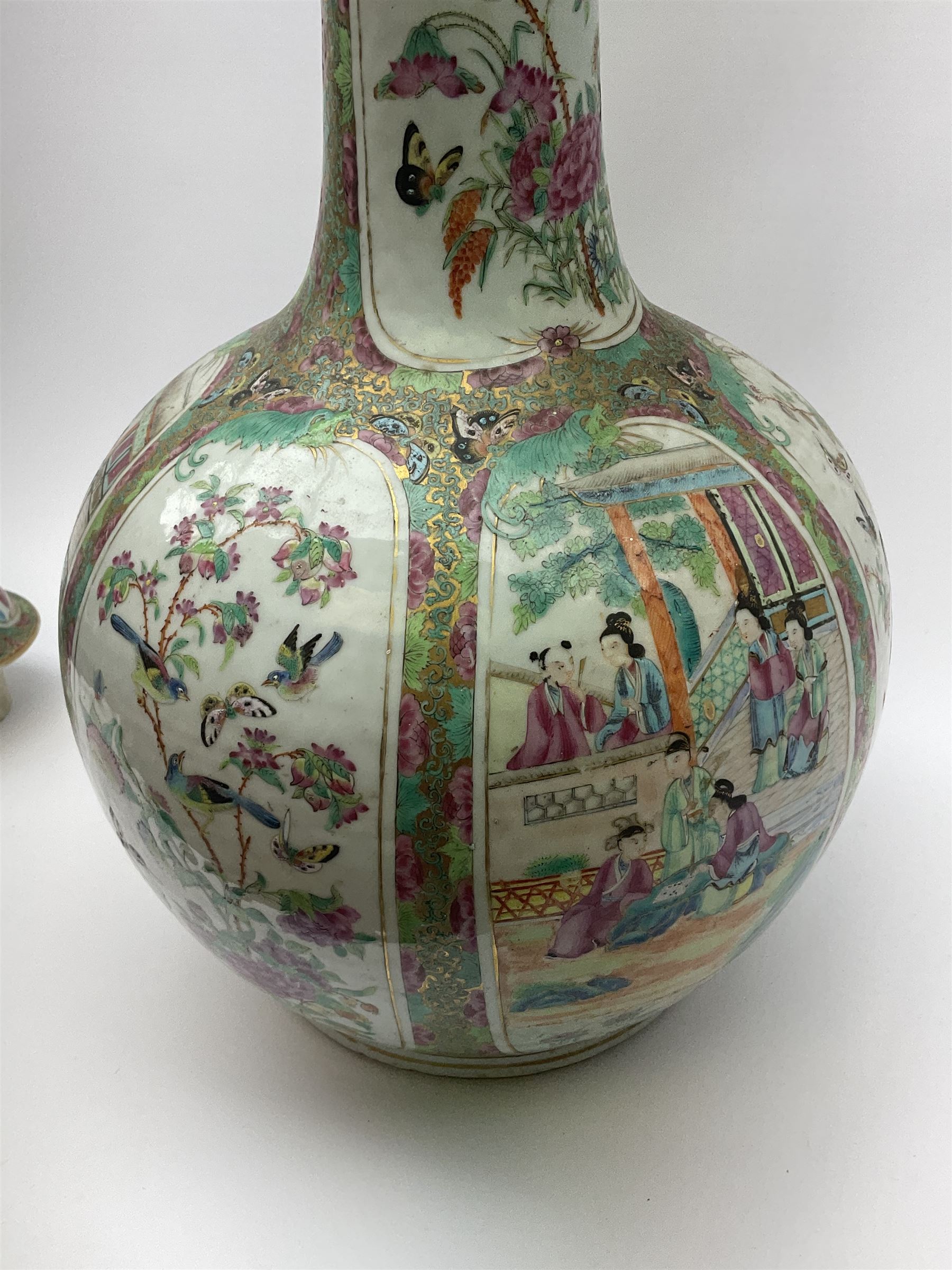 A 19th century Chinese Canton Famille Rose vase, of globular form with tall neck, and cover with finial, decorated with alternating panels of figural scenes, and birds and butterflies amongst blossoming and fruiting trees, with foliate surround against gilt, overall H57cm. 