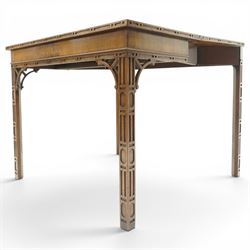 George III Chippendale design mahogany table, the rectangular hinged top with geometric carved edge, opening to reveal a baize-lined interior supported by twin concertina rear gateleg supports, over a banded frieze and pierced C-scroll spandrels, the inner chamfered square supports carved with geometric blind-fretwork detail