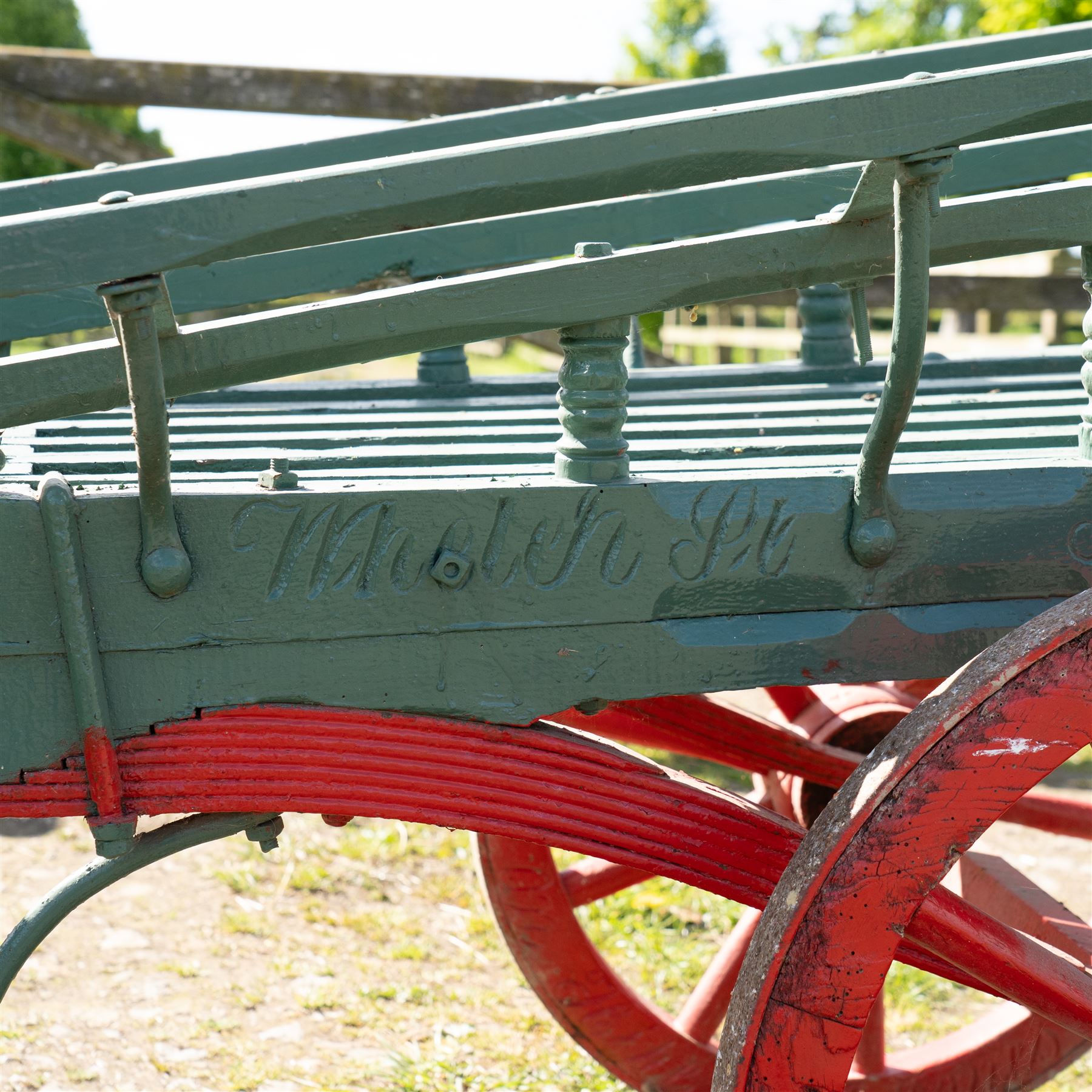 Costermonger’s Cart

A painted costermonger’s cart with green slatted timber body, red painted wooden spoked wheels and red leaf spring suspension. The cart is fitted with raised side rails, turned supports and short projecting handles. Painted lettering is visible along the side rails, together with the number “661” to the frame and wheel rim.
Finished in traditional colours, the cart offers excellent decorative appeal and would be suitable for display, garden or country house settings.

Dimensions:
Overall length: 240 cm
Body length: 215 cm
Width: 94 cm
Height: 86 cm
Wheel diameter: 64 cm

Features:
Timber construction
Open slatted carrying platform
Shaped side rails
Leaf spring suspension
Wooden spoked wheels
Iron tyres
Iron fittings throughout
Carved ownership and maker inscriptions
Traditional painted finish

