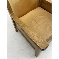 'Mouseman' oak smokers armchair, panelled sides, slung tan leather back and upholstered seat cushion, by Robert Thompson of Kilburn