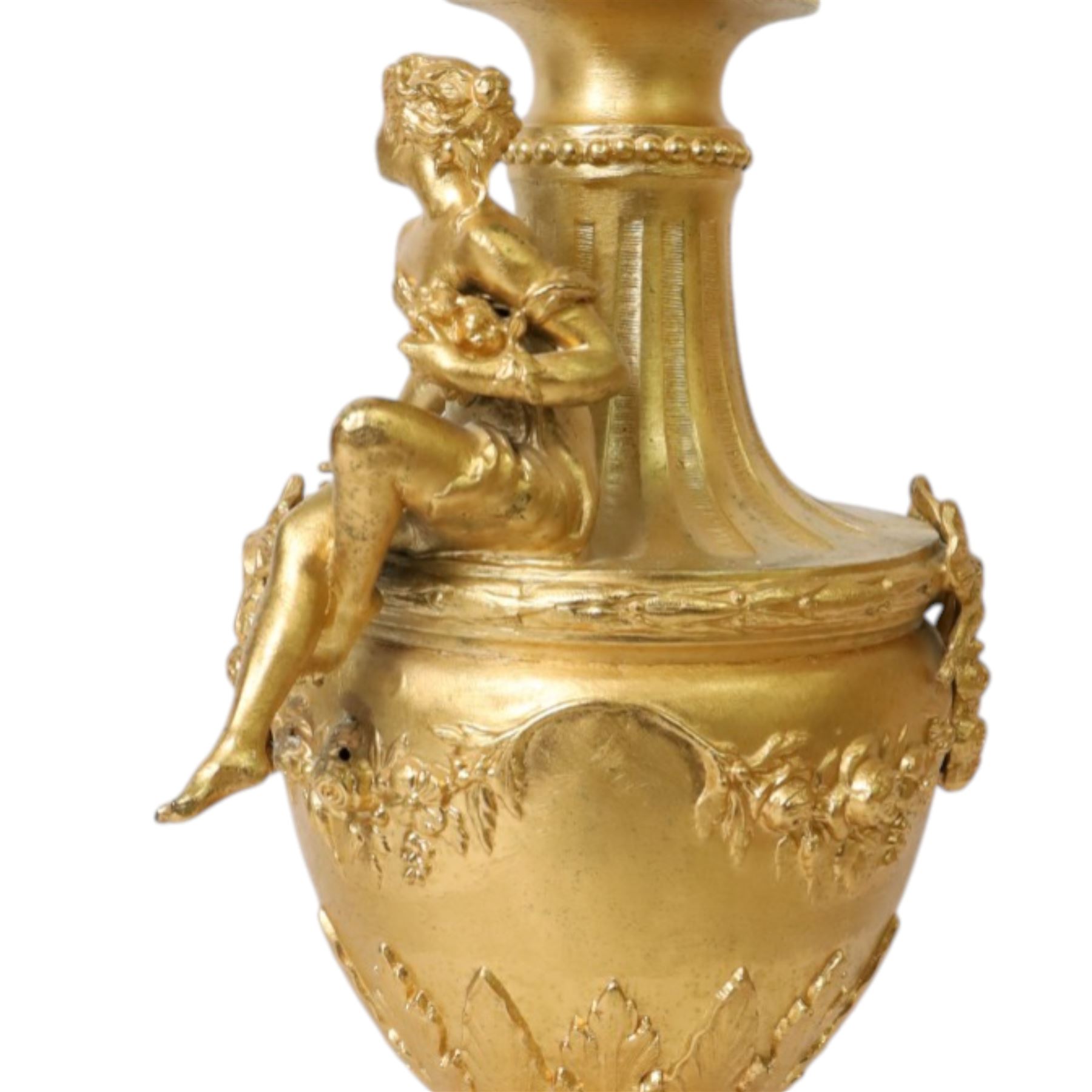 Pair of Rococo style gilt metal table lamps, the urn shaped bodies each with applied figure seated upon shoulder, and female mask to opposite side issuing scroll leading to top of neck, the body cast and applied with stiff leaf detail, and foliate swags and wreaths, upon square pink marble plinths with applied gilt metal mask mounts, and four gilt metal bracket feet, each supported a pleated cream silk closed top lampshade, H63cm