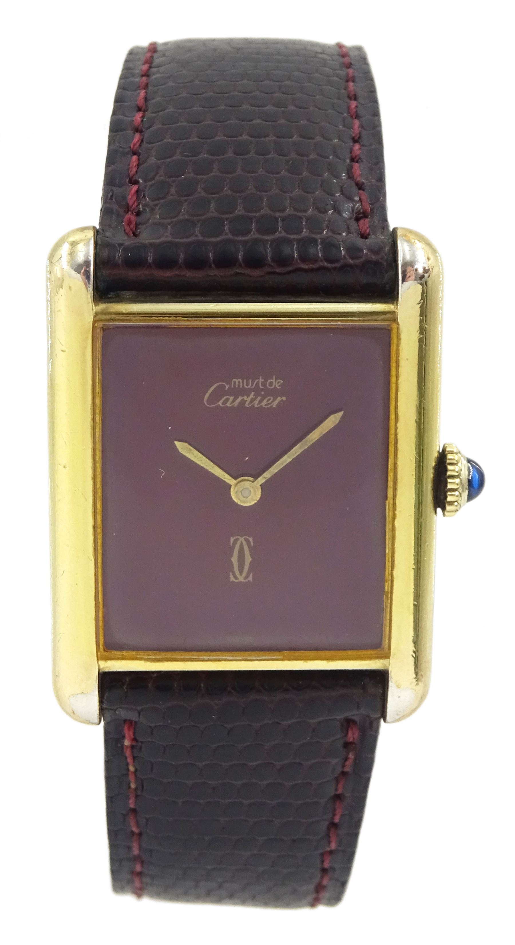Must de Cartier silver-gilt manual wind wristwatch, burgundy dial, back case No 6 141961, hallmarked, on Cartier burgundy leather strap, with gilt buckle boxed with certificate of origin dated 1981