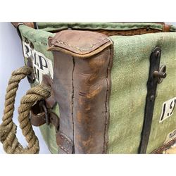 WW2 British Army RAMC 'Regimental Medical Pannier', well marked externally and dated 1941, stamped May 1943 internally, canvas covered wicker form with leather edges, hinged top and fall front with two rope carrying handles, fitted iron locking straps with securing chains; contains various unused field dressings and bandages with WW2 dates and two pillows; original label under lid L79cm