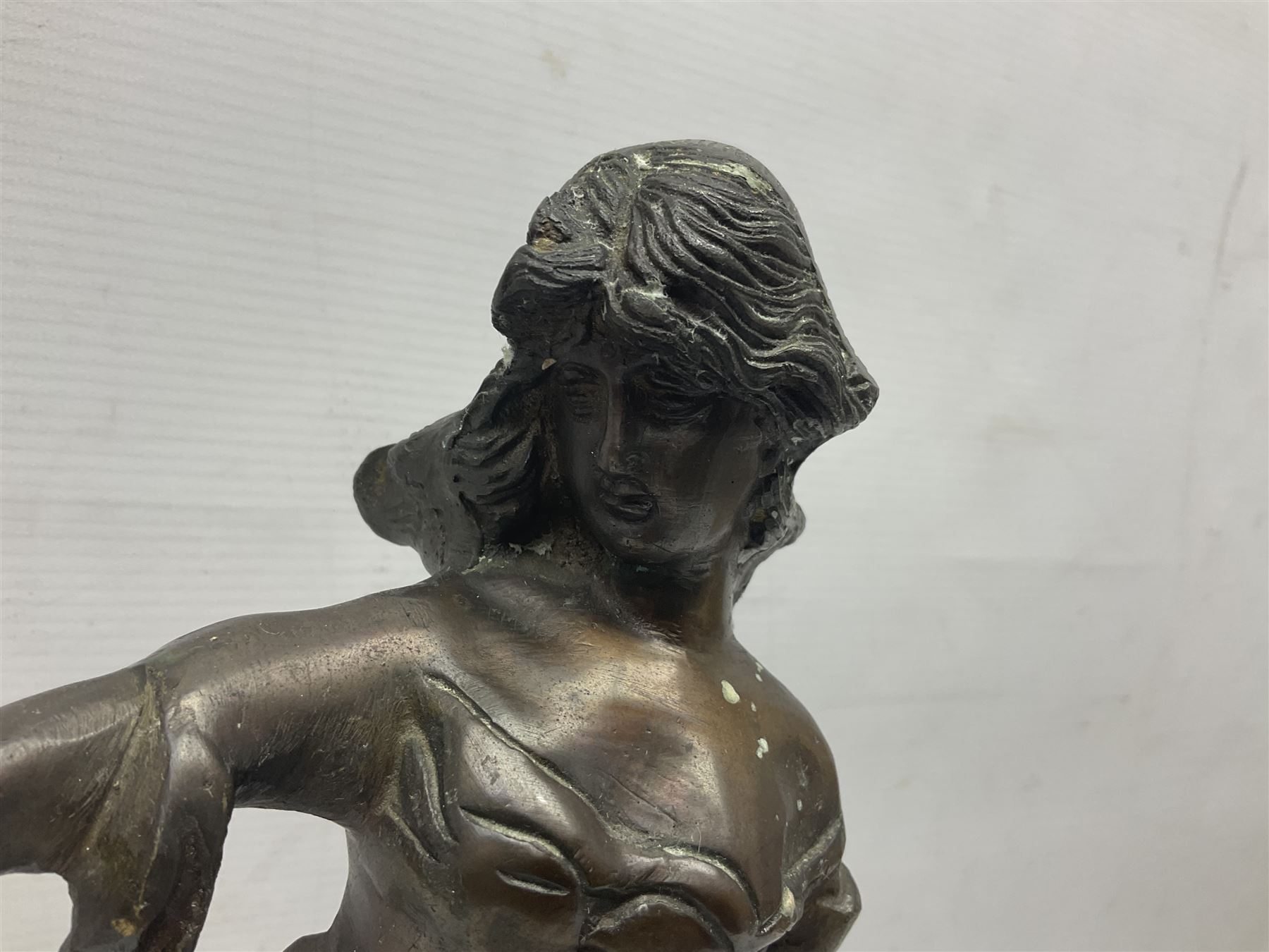 Bronzed figure of a woman, with bird perched upon her outstretched arm ...