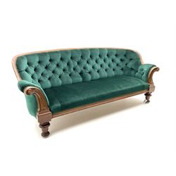 Victorian mahogany settee, upholstered in green buttoned fabric, moulded frame and scroll carved arm terminals, turned supports