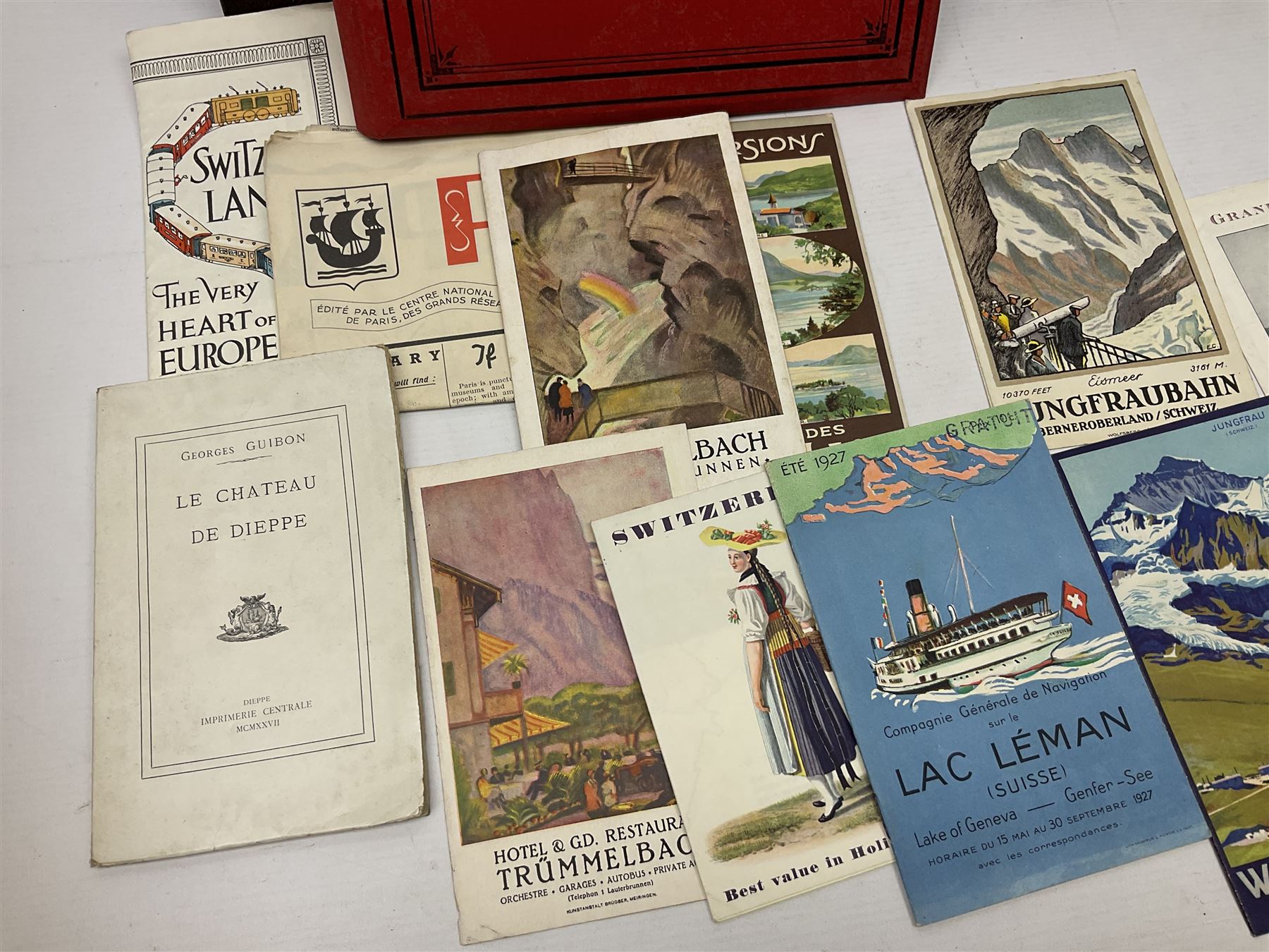 Early 20th century ephemera, to include signed photographs of Charles Boyer and Walter Pidgeon etc, a printed letter from Winston Churchill, two albums and a quantity of transfer books of Players and similar cigarette cards, including Boy Scout and Girl Guide Patrol Signs and Emblems and RAF Badges, a collection of greetings cards and postcards, a photograph album containing black and white photographs of Caius College Cambridge and guides and pamphlets on travelling Switzerland and the UK