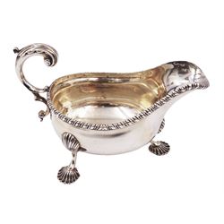 Victorian silver sauce boat, of typical form with oblique gadrooned rim and acanthus capped flying C scroll handle, upon three shell pad feet, hallmarked Charles Stuart Harris, London 1898, including handle H10cm