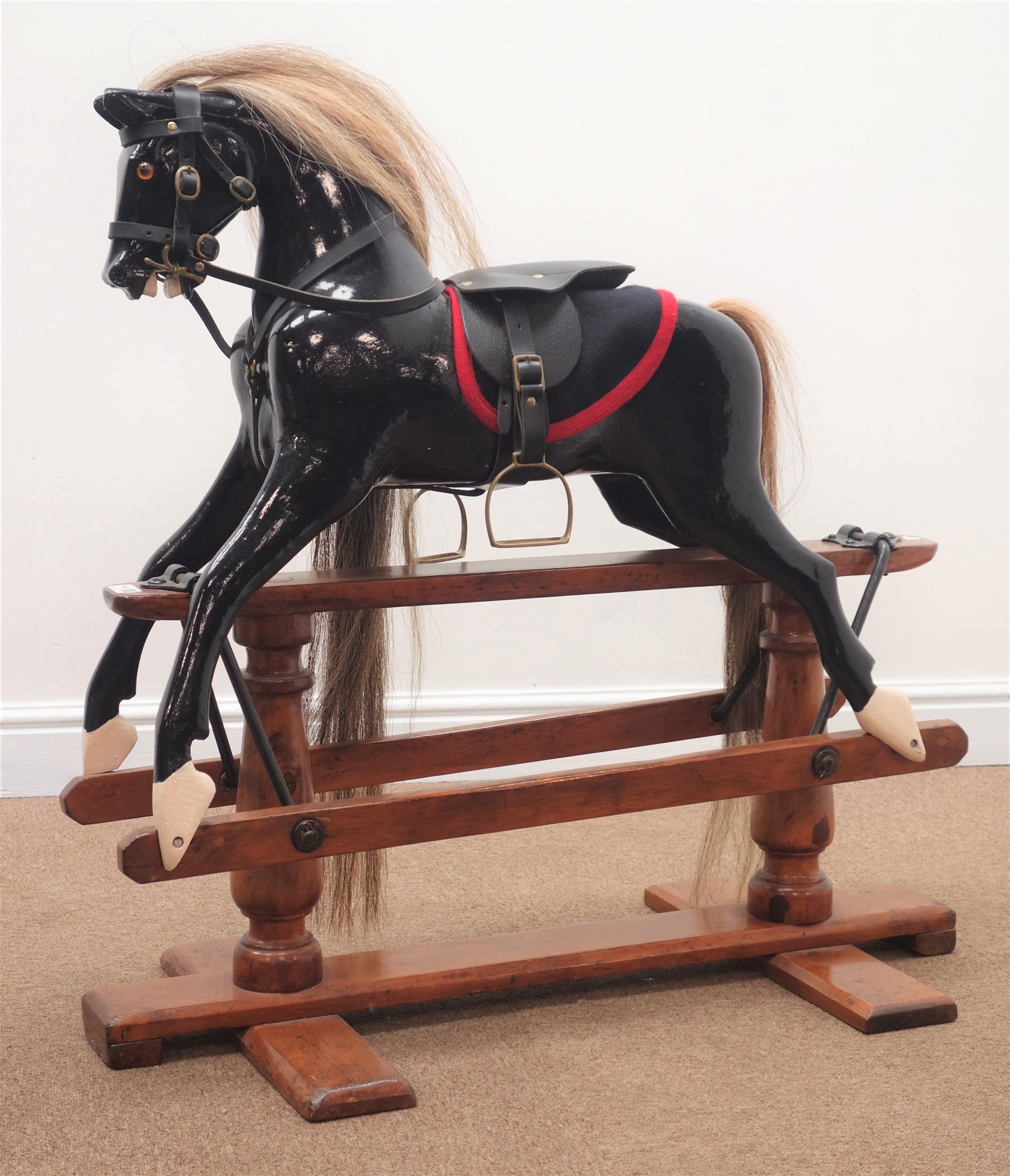 19th century painted rocking horse, saddle stirrups and briddle, trestle base, L90cm, H86cm