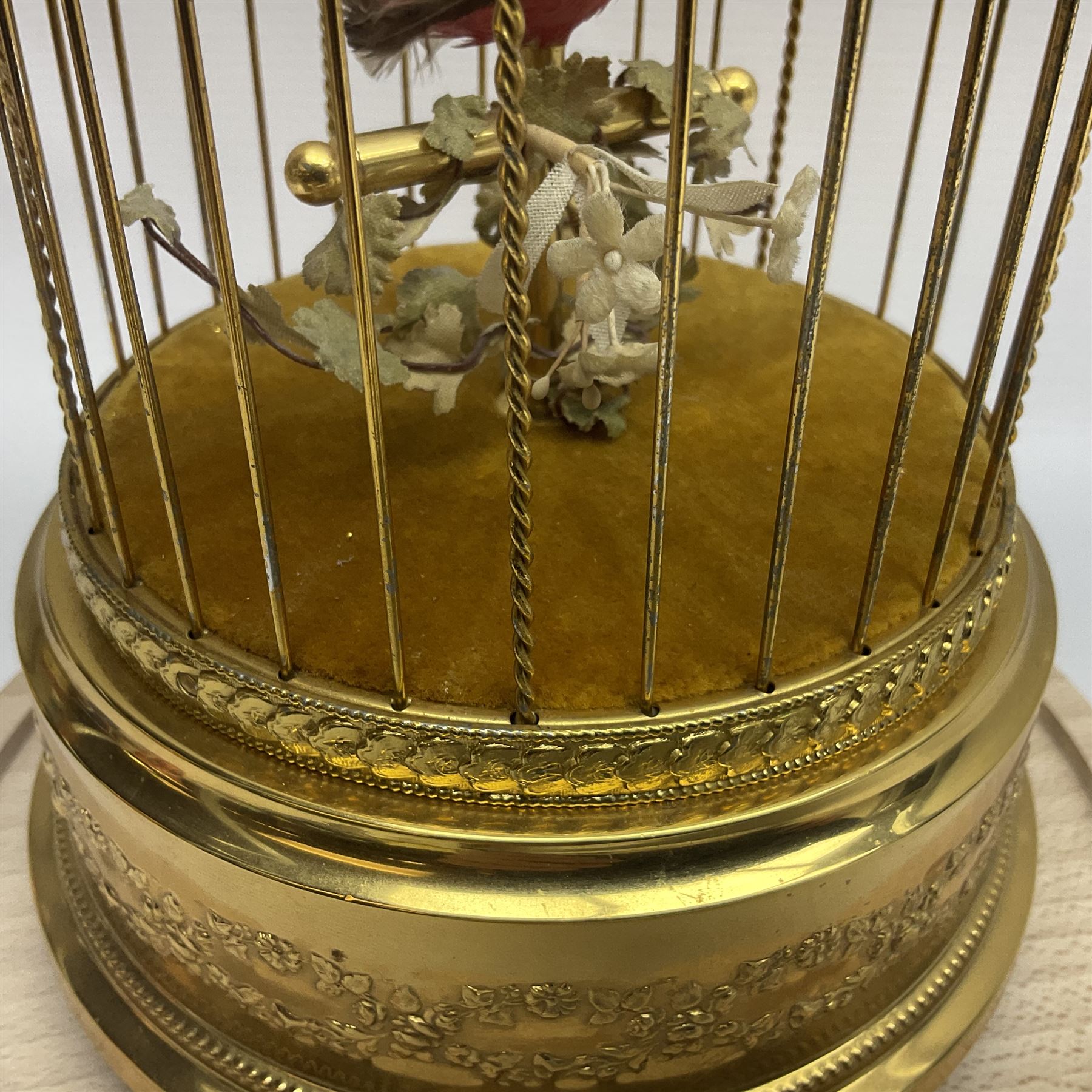 Swiss Reuge Music bird cage automaton music box, the bird with articulated head and beak, in a gilt brass cage, with a glass dome and stand, H30cm
