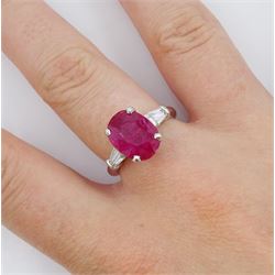 18ct white gold ruby and diamond ring, the oval cut ruby of 4.16 carat, with two tapered baguette cut diamonds set either side, hallmarked