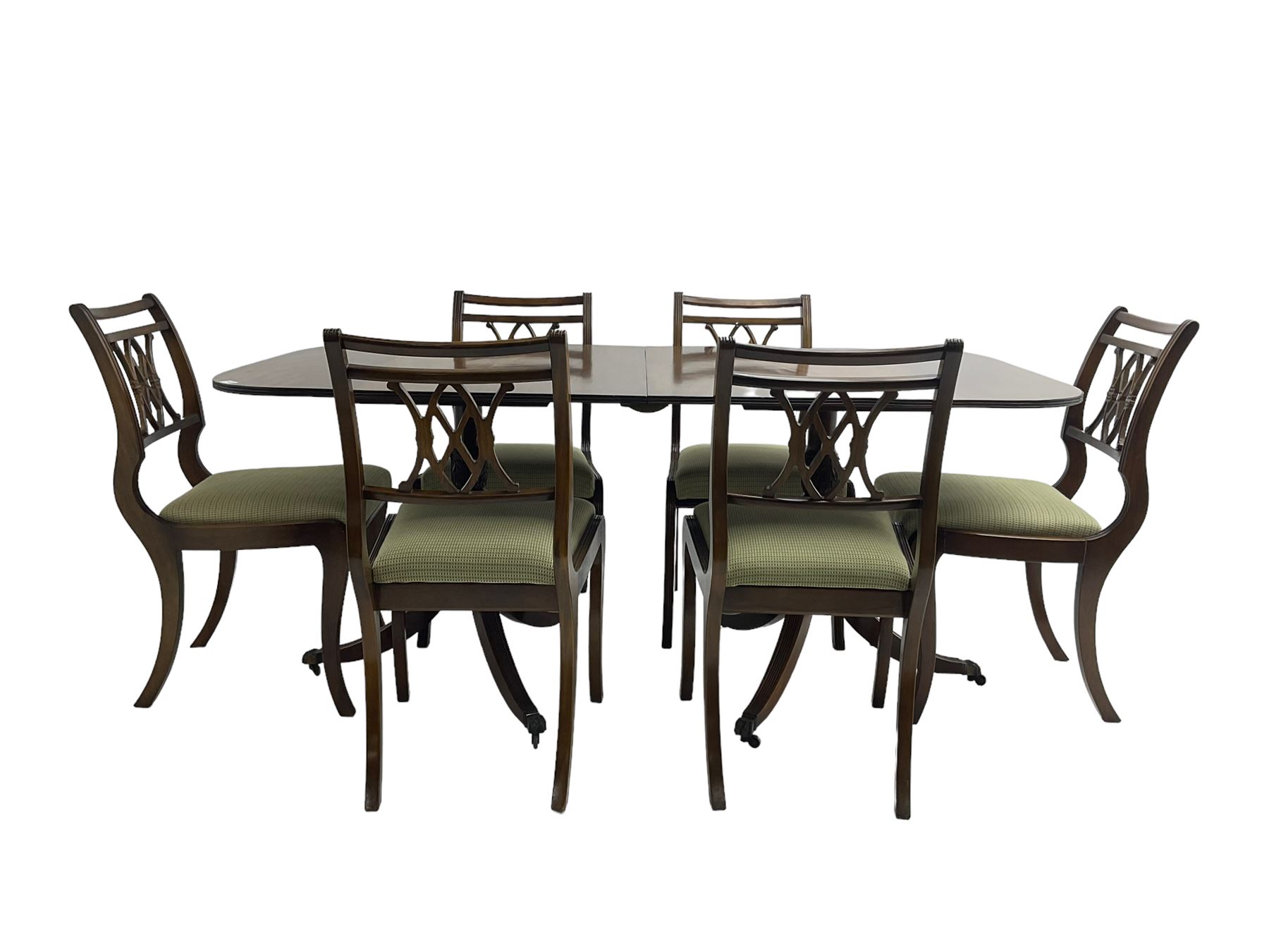 Regency design mahogany twin pedestal dining table, rectangular top with reeded edge, acanthus carved turned column terminating in reeded tripod base with hairy paw feet and castors (W172cm D92cm H75cm) and set eight (6+2) Regency design mahogany dining chairs, pierced back with scroll design, seat upholstered in patterned laurel green fabric, raised on reeded sabre supports (W48cm H88cm)