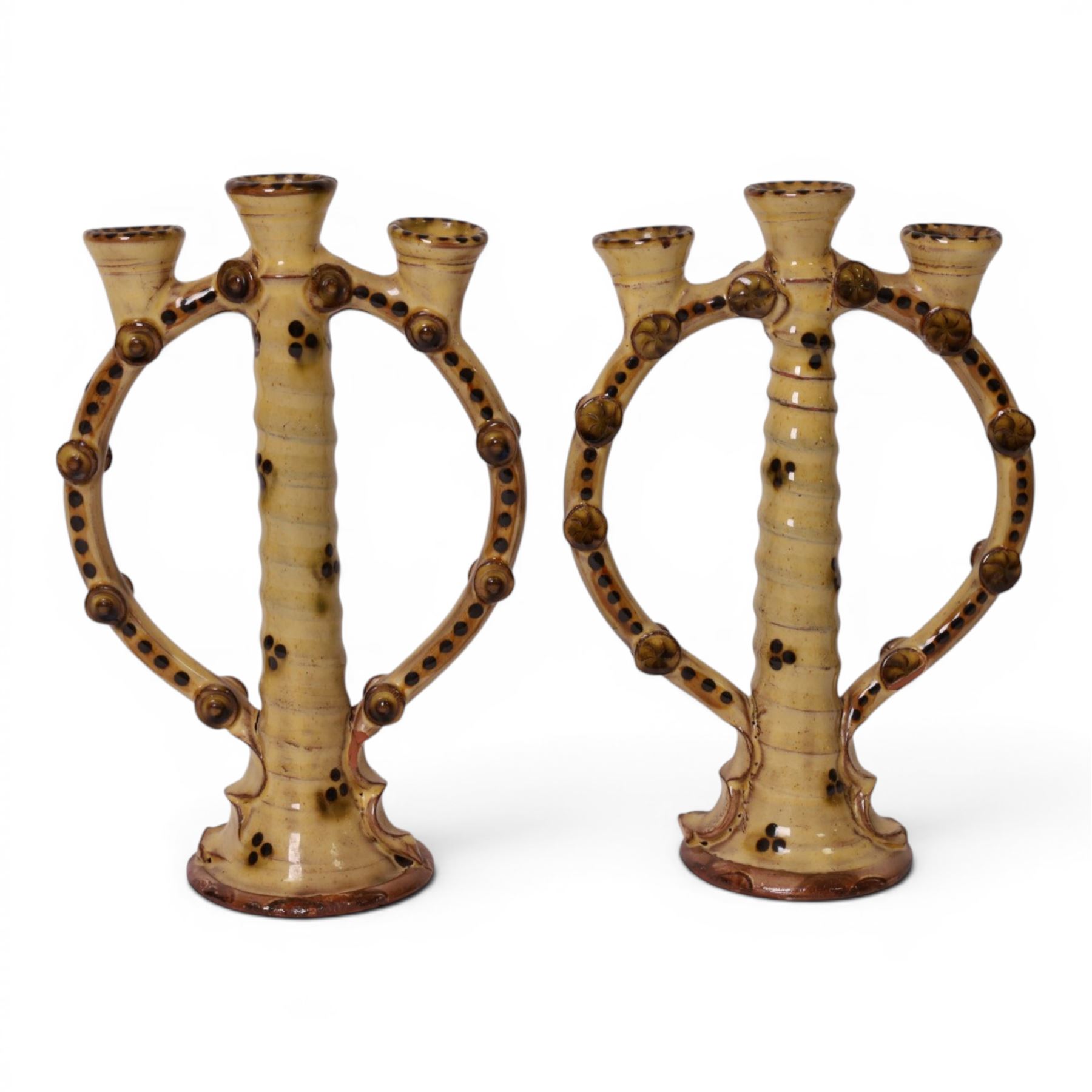 Pair of studio pottery candlesticks, with a central twisted column bordered by circular supports, H24cm 