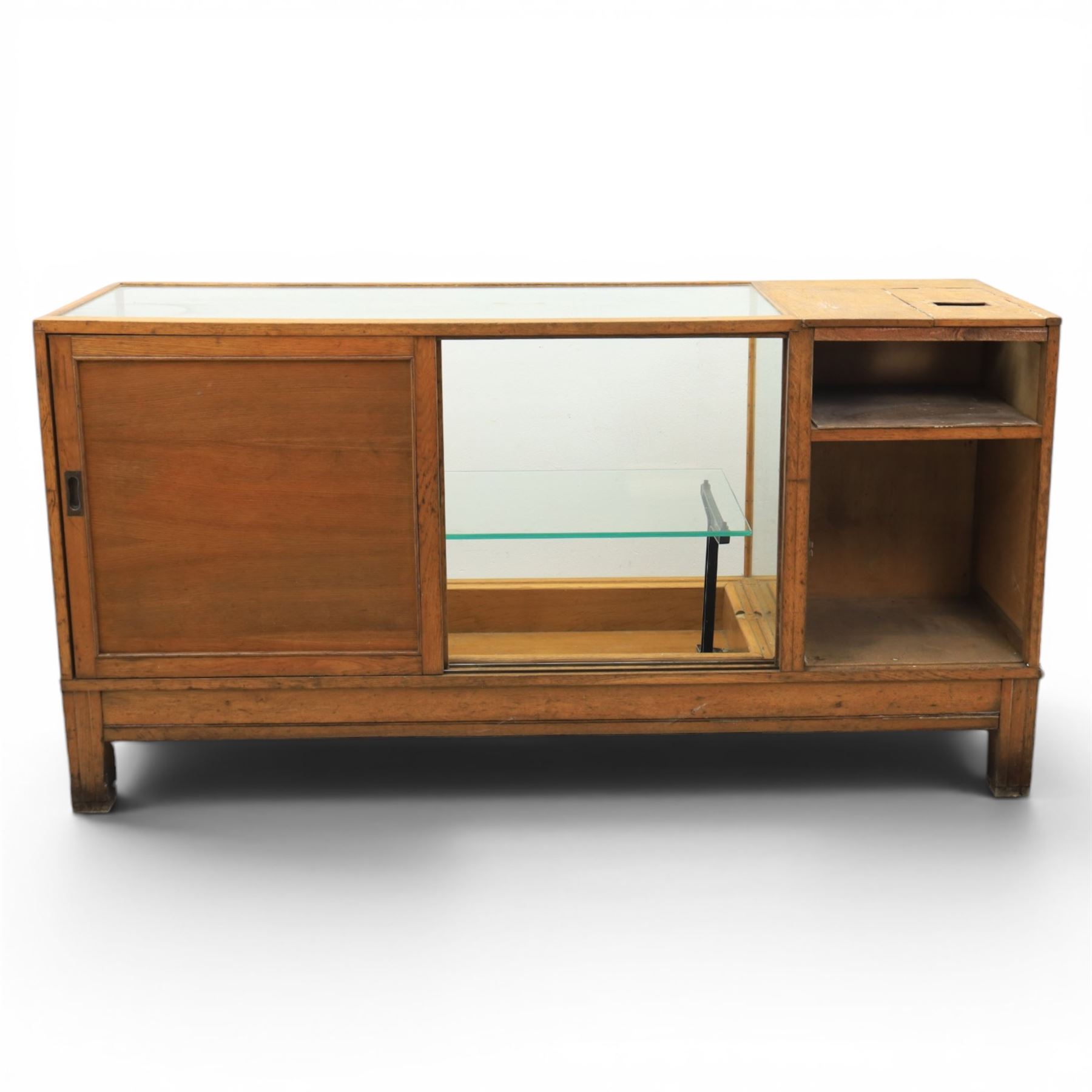 Early 20th century oak framed and glazed haberdashery shop counter with sliding doors and cupboards