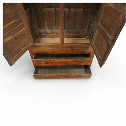 Georgian rustic oak housekeeper’s cupboard, moulded cornice above a pair of fielded panel cupboard doors enclosing a boarded interior with central divider and hanging hooks, the base fitted with two long drawers with brass swan neck handles, raised on stile supports