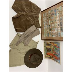 Mid 20th century Boy Scouts uniform, comprising corduroy shorts, further pair of shorts, two shirts, socks, and felt hat, together a framed collection of Ogden's 'Boy Scots' cigarette cards, and an unframed print of Lord Baden Powell. 