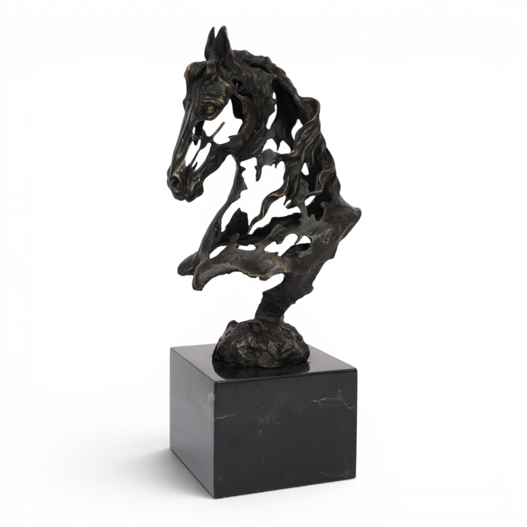 Stylised bronze model of an openwork horses head, signed Gadi and with foundry mark, raised upon black marble plinth, H41cm
